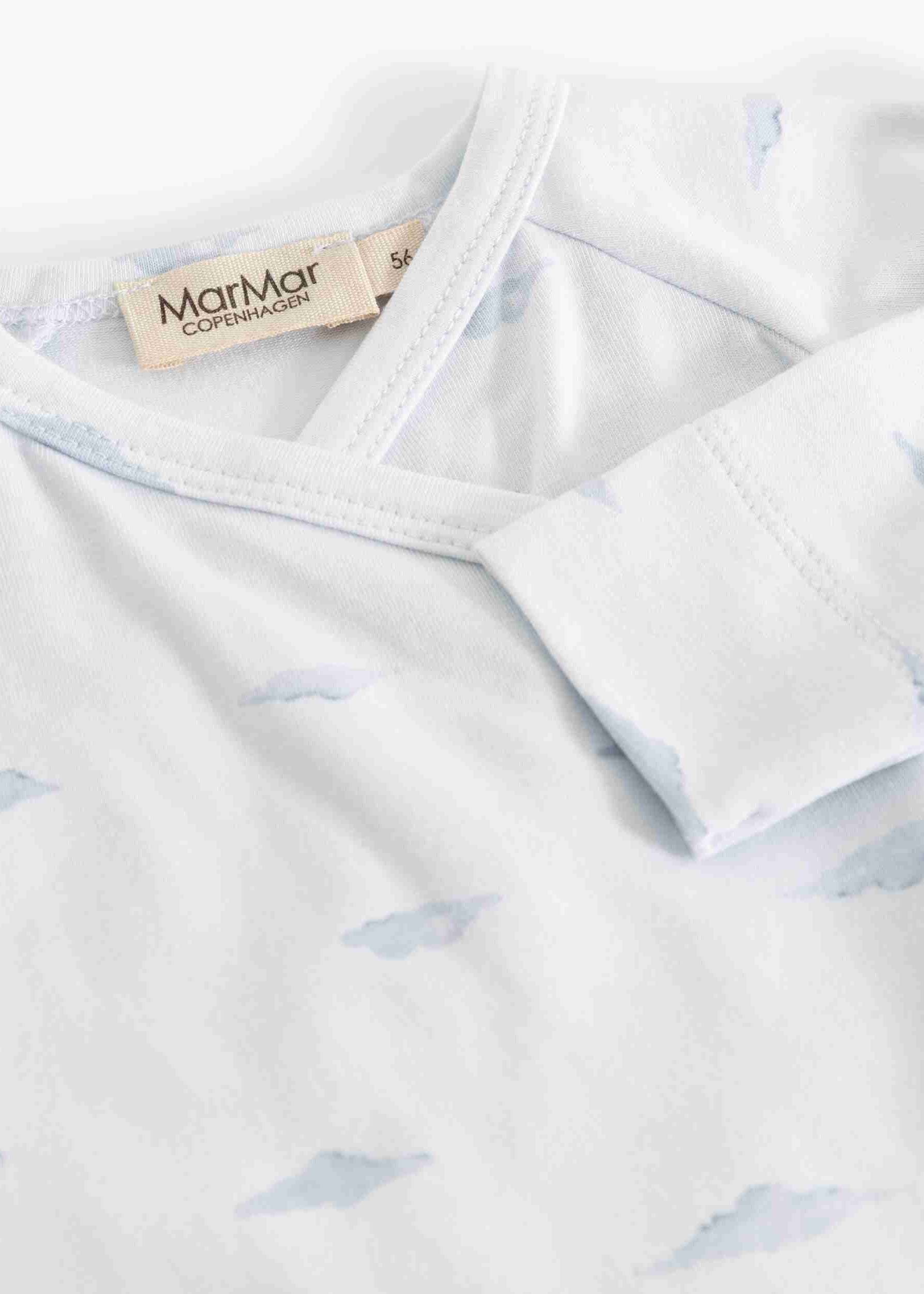 Close-up of a white baby long-sleeve top with a light blue cloud print and a visible MarMar brand label.