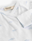 Close-up of a white baby long-sleeve top with a light blue cloud print and a visible MarMar brand label.