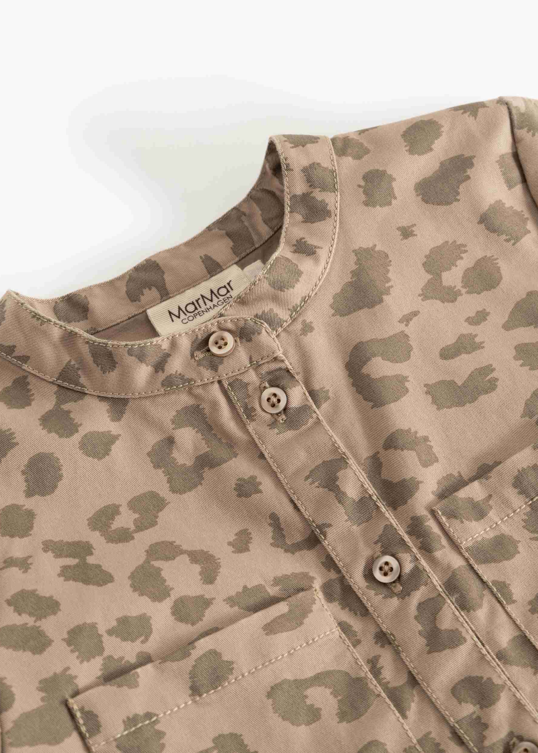Close-up of a children's long-sleeve shirt with a beige and brown leopard print pattern, featuring a mandarin collar and button-down front.