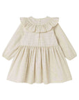 A long-sleeve baby dress in a cream and white micro-check pattern, featuring a ruffled collar and a gathered skirt, shown against a plain white background.