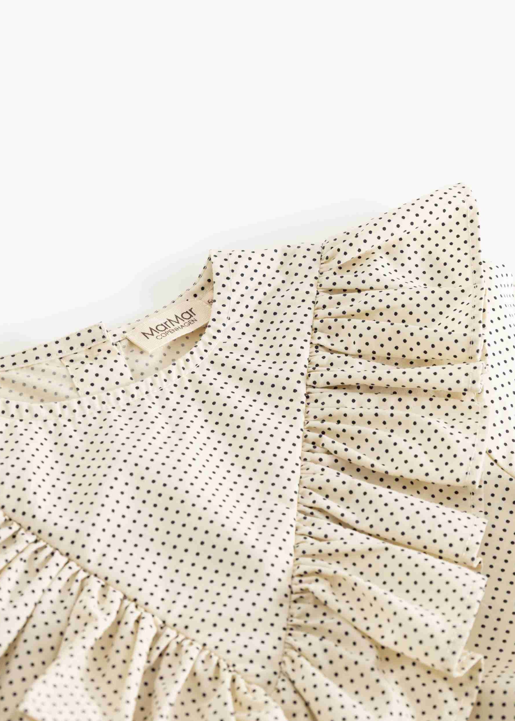 Beige dress with ruffled sleeves and a subtle pattern on a white background