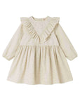 A long-sleeve baby dress in beige with a tiny white polka dot pattern, featuring a ruffled V-neckline and a gathered skirt, shown on a plain white background.