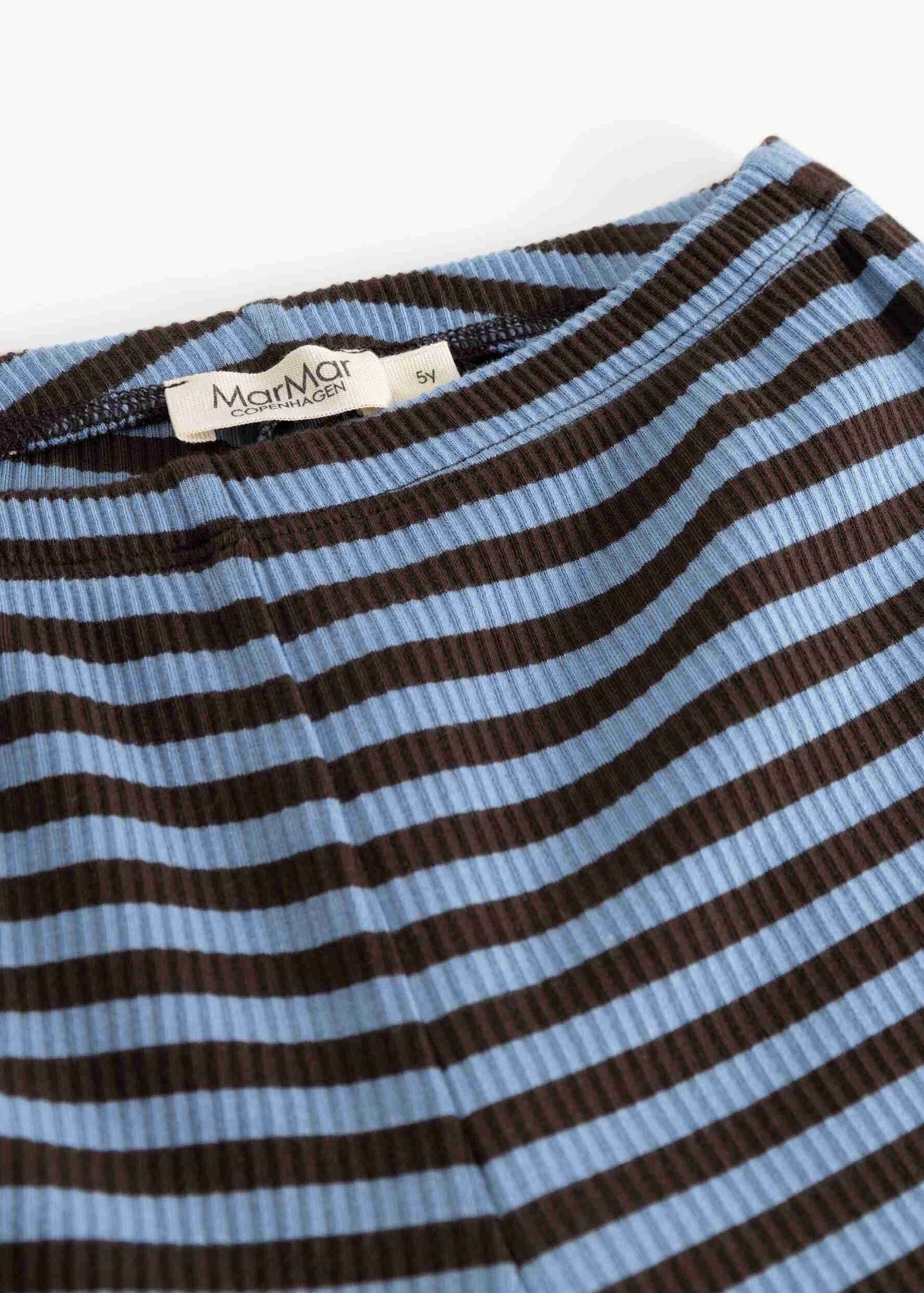 Close-up of a ribbed knit garment with horizontal brown and light blue stripes, showing a white neck label that reads 'MamMia'.