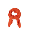A bright orange ribbed knit scarf tied in a knot, displayed on a clean white background.