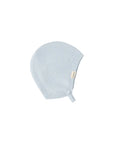Light blue knitted baby hat with a brand label on a white background