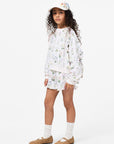 Young girl wearing a floral outfit with a white background