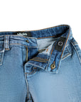 Close-up of blue jeans with collar and brand logo on a white background