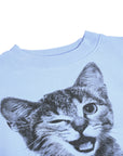 Light blue sweatshirt with a black and white cat graphic on a white background