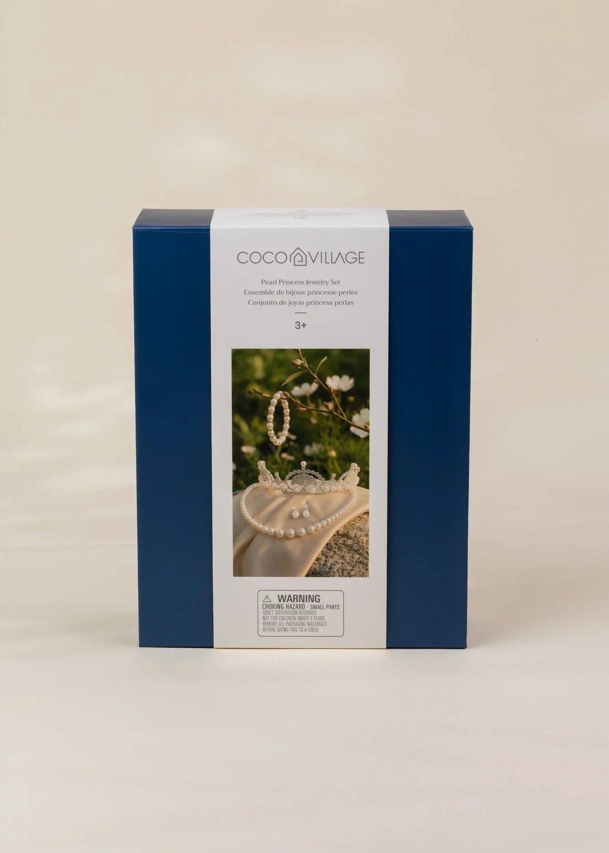 A square blue and white product box for Coco Village bead jewelry kits, featuring a photo of a pearl heart and jewelry on the front, set against a plain beige background.