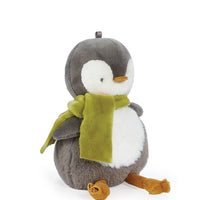 Stuffed penguin toy with a green scarf on a white background