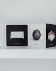 Collection of card decks with sports-themed designs on a white shelf.