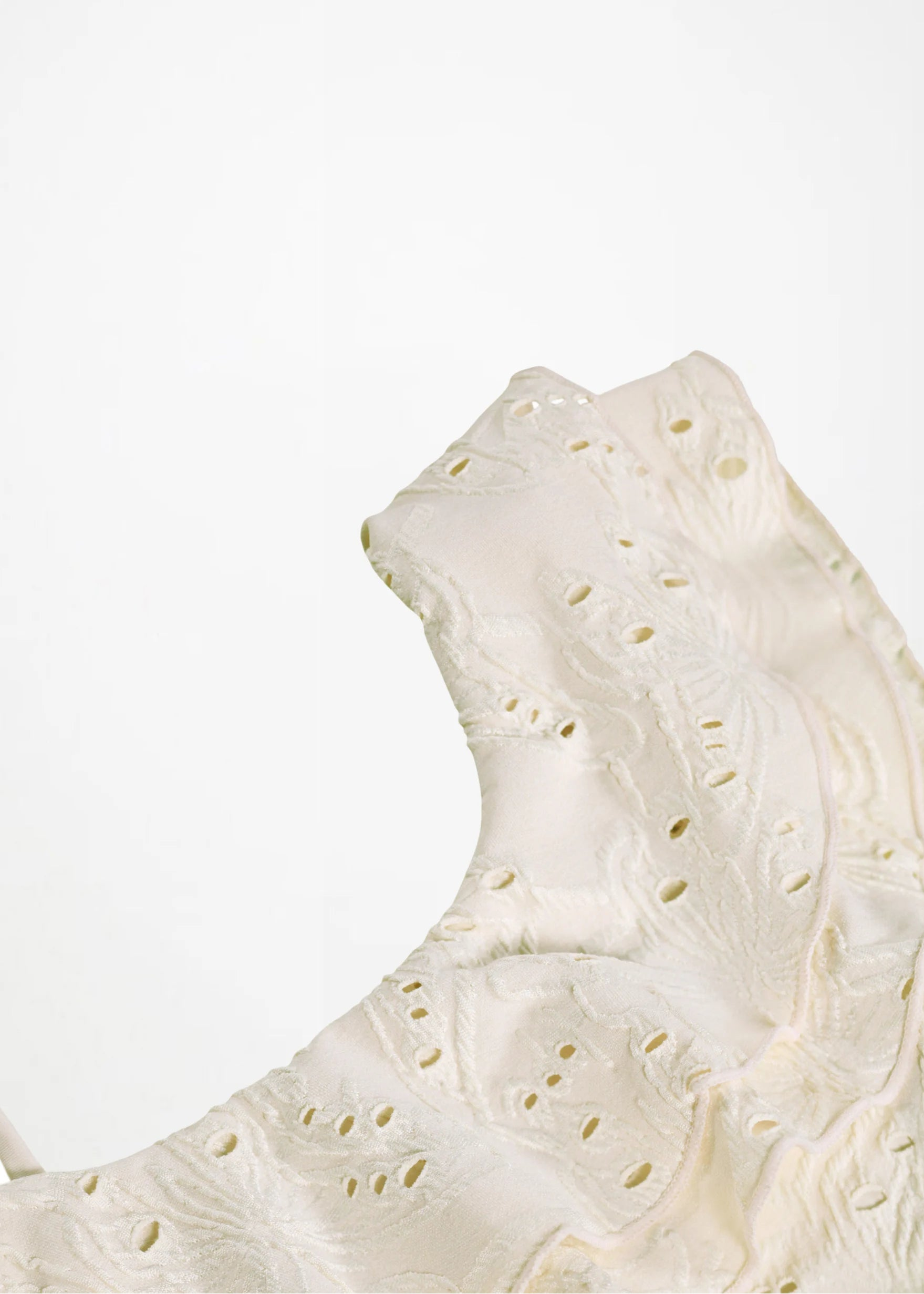 Close-up of a textured white ceramic plate on a light background