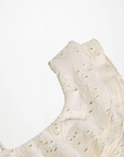 Close-up of a textured white ceramic plate on a light background