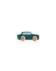 Green toy car with wooden wheels on a light beige background