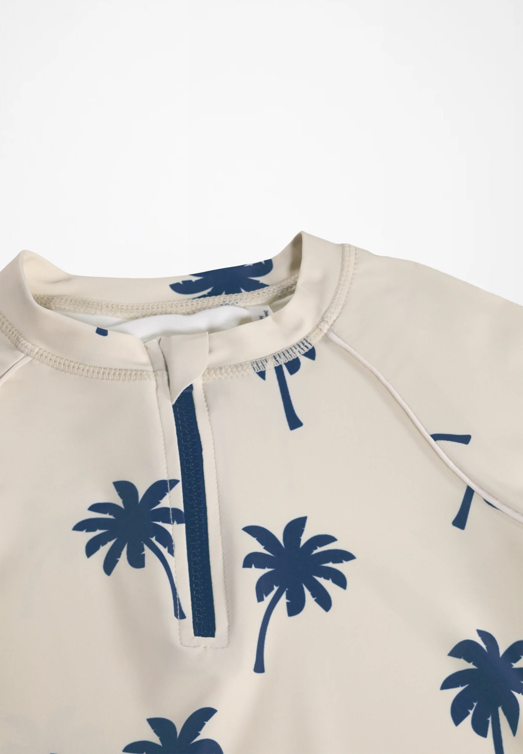 Beige hoodie with blue palm tree patterns on a white background