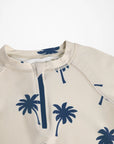 Beige hoodie with blue palm tree patterns on a white background