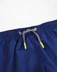 Navy blue shorts with a drawstring on a light gray background