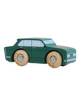 Green toy car with wooden wheels on a light gray background