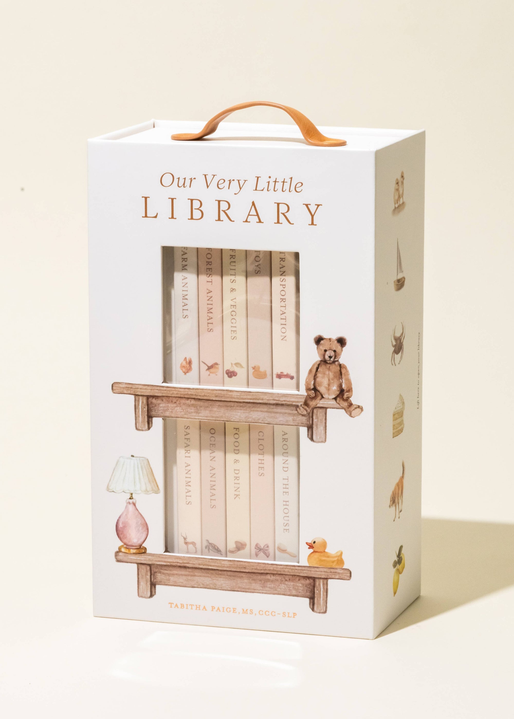 Box packaging for 'Our Very Little Library' with illustrations of books and a teddy bear.