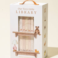Box packaging for 'Our Very Little Library' with illustrations of books and a teddy bear.