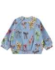 A light blue long-sleeve baby sweater featuring an all-over print of colorful ribbon bows in various floral and patterned designs, shown against a plain white background.