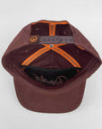 Brown cap with orange interior on a white background