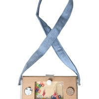 Wooden toy with colorful balls inside, attached to a blue ribbon on a white background