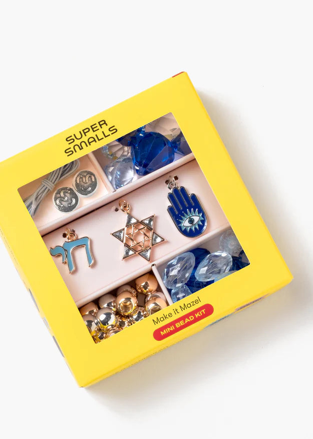 Yellow box containing colorful jewelry pieces with 'Super Smalls' branding.