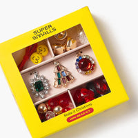 Colorful jewelry set in a yellow box labeled 'Super Smalls' on a white background