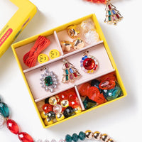 Colorful jewelry set with earrings and necklaces displayed in a yellow box on a white background.
