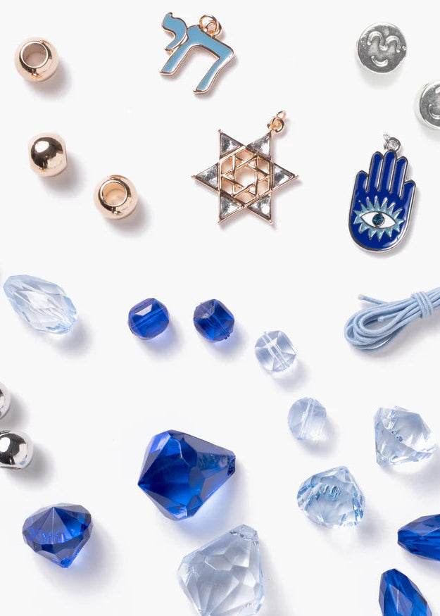 Collection of jewelry charms and beads on a white background