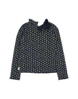 A long-sleeve top with a dark navy base and a dense, small-scale floral pattern in light green, yellow, and white. It features a high, ruffled mock neck collar with a tie detail at the back, shown against a plain white background.
