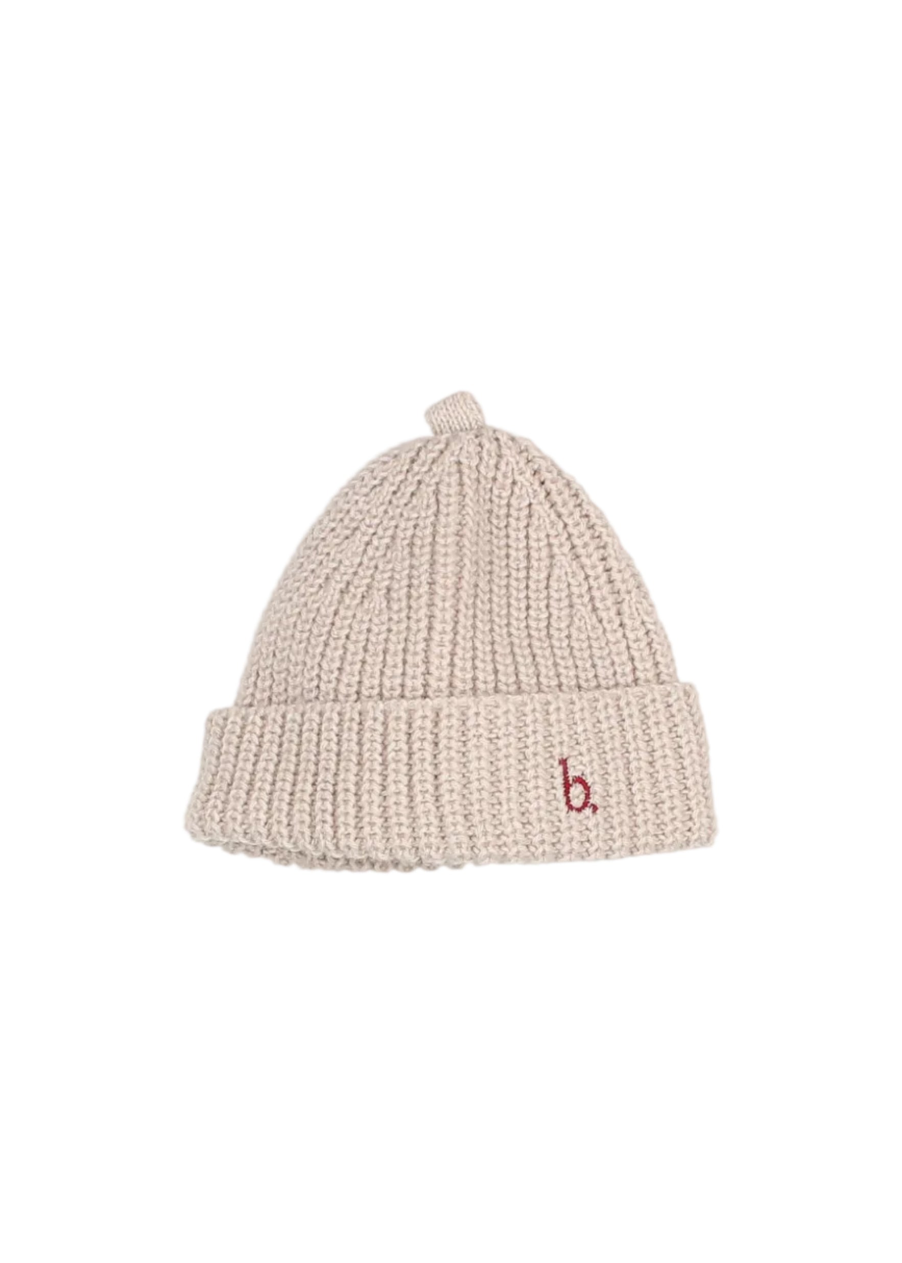 A light beige ribbed knit beanie hat with a small red embroidered lowercase 'b' logo on the front cuff, shown against a plain light gray background.