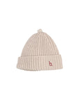 A light beige ribbed knit beanie hat with a small red embroidered lowercase 'b' logo on the front cuff, shown against a plain light gray background.