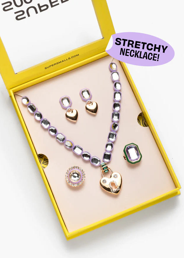Necklace set with heart and gemstone pendants in a yellow box, labeled 'Stretchy Necklace'.