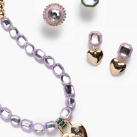 Jewelry set with heart-shaped pendants on a white background