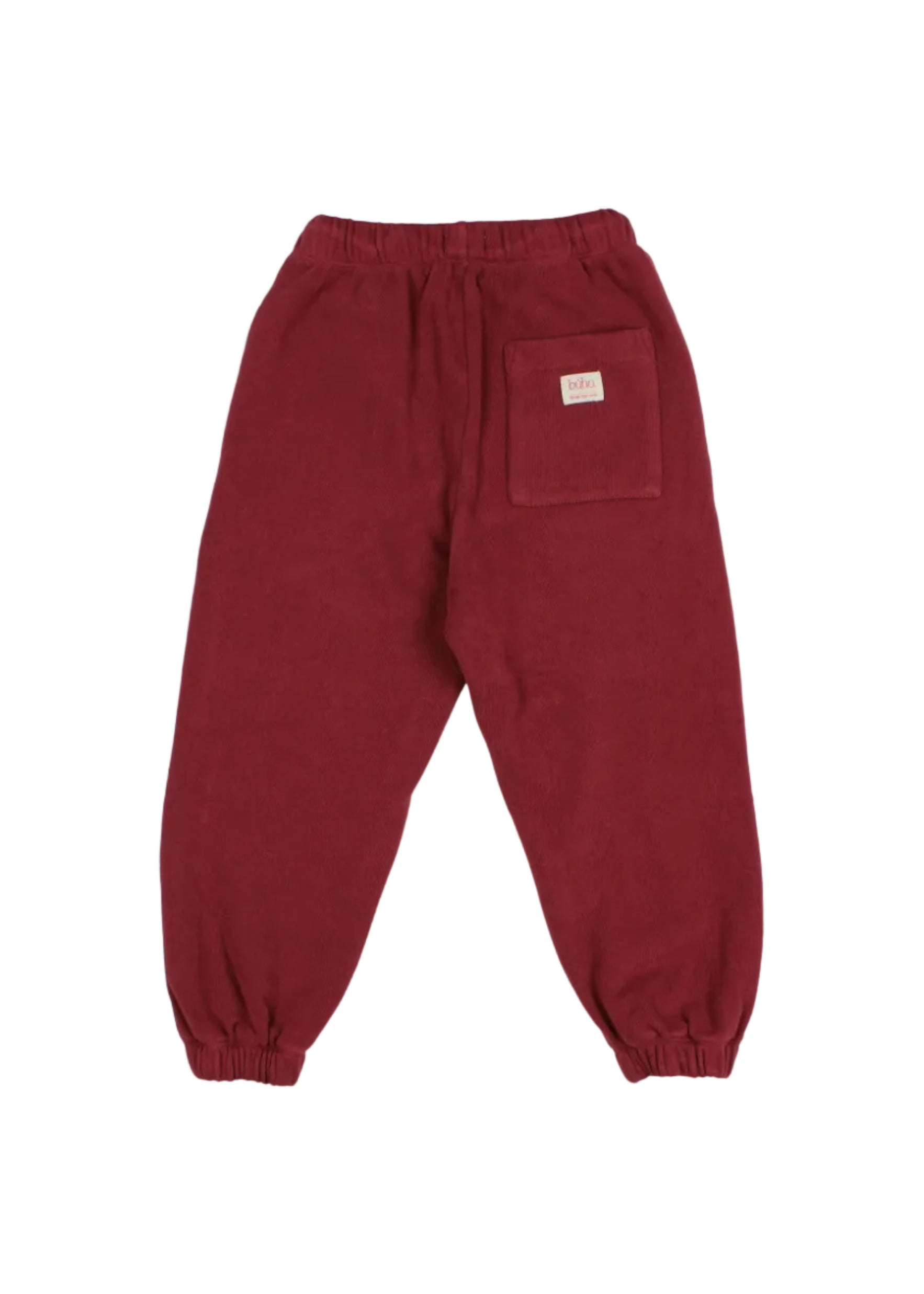 A pair of dark red corduroy jogger pants with an elastic waistband and cuffs, featuring a back pocket with a small white label, shown against a plain white background.