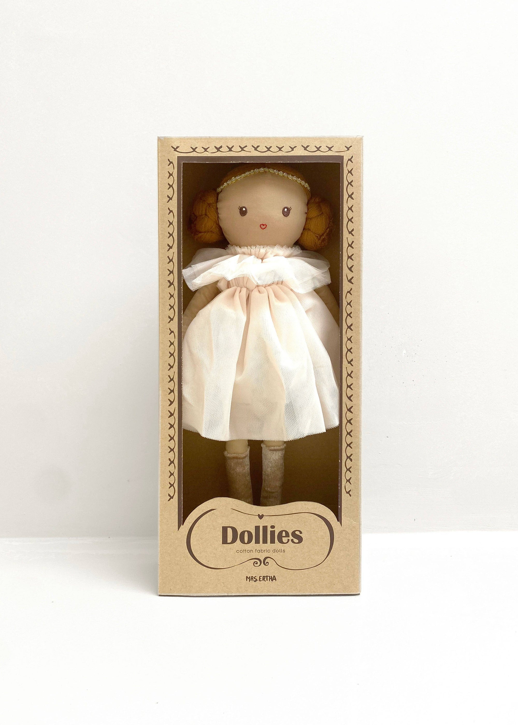 Toy doll in a cardboard box with 'Dollies' branding on a white background