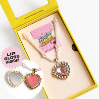 Heart-shaped lip gloss and earrings set in a yellow box with 'Lip Gloss Inside!' text.