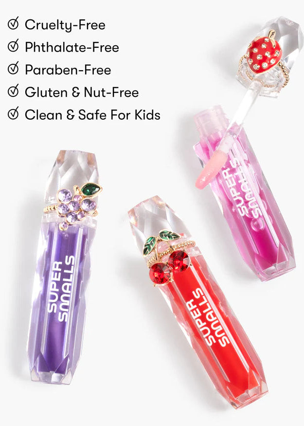 Super Snails lip balms in purple, red, and pink on a white background with safety certifications listed.