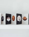 Row of books with sports-themed illustrations on a white shelf