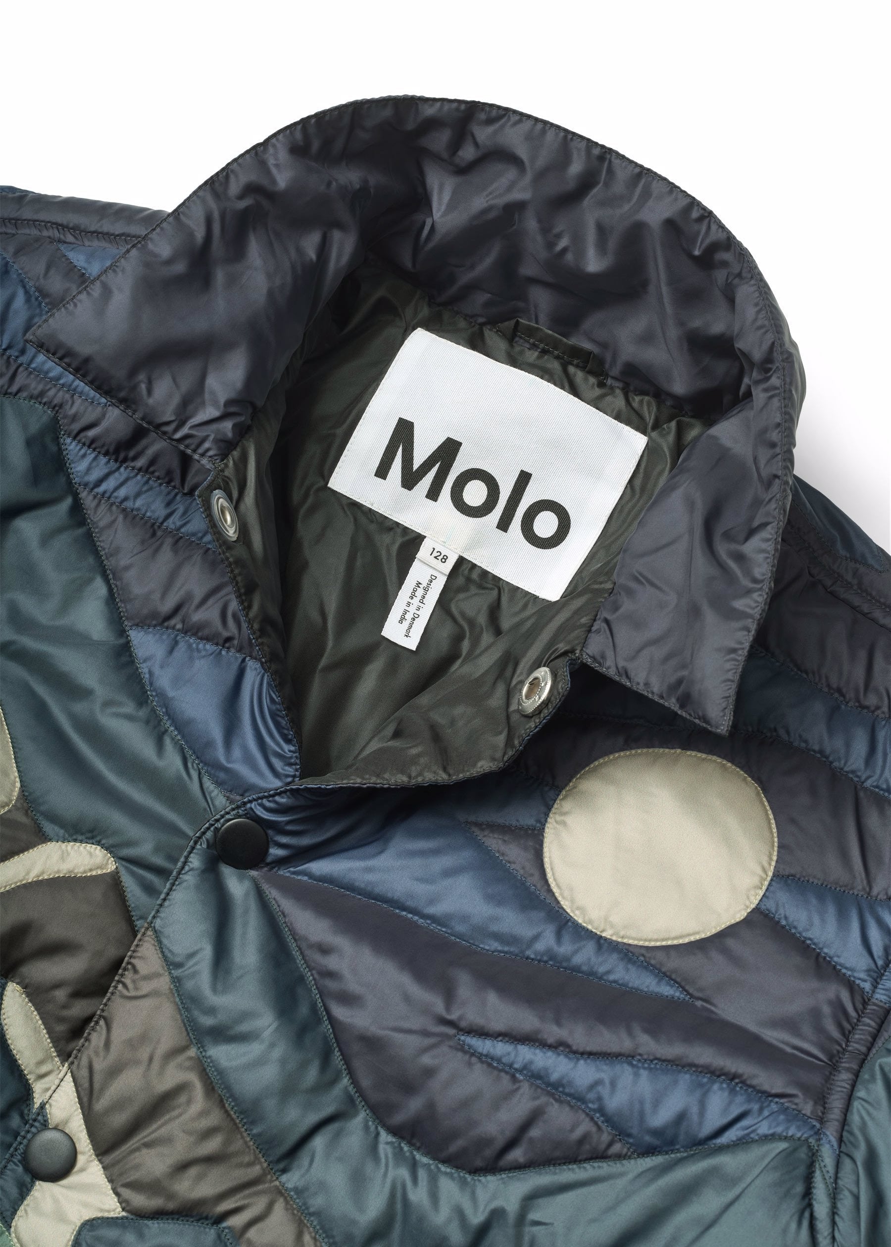 Close-up of a jacket with a Molo label on a white background