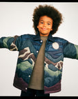 Person wearing a colorful camouflage jacket on a plain background