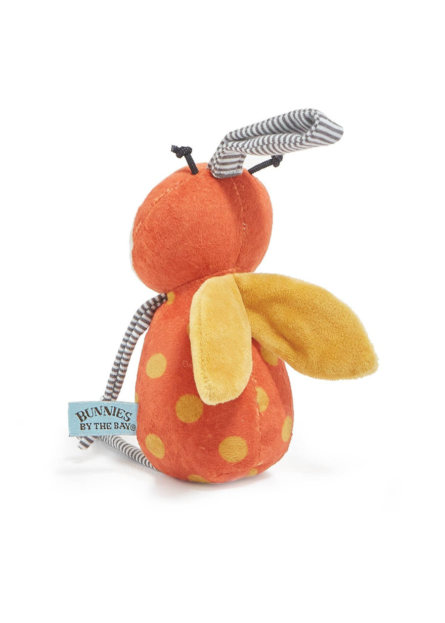 Plush toy resembling a ladybug with an orange body and yellow spots on a white background
