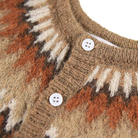 Close-up of a patterned sweater with buttons on a white background