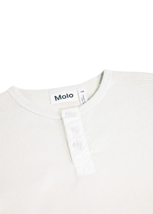 Close-up of a white garment with 'Molo' branding on a white background