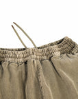 Close-up of beige corduroy pants with a white background
