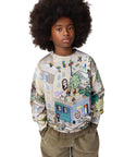 Child wearing a colorful patterned sweatshirt on a white background