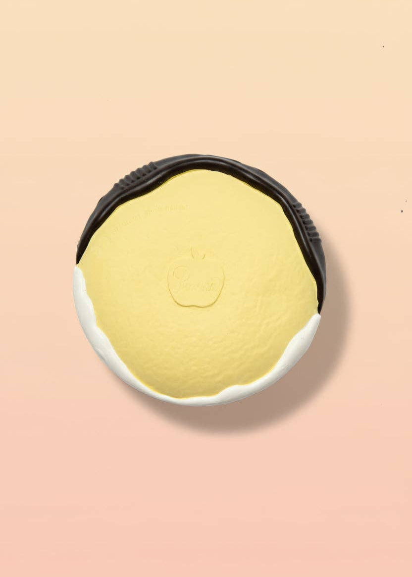 Yellow sponge with black rim on a beige background
