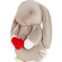 Plush bunny toy with a red heart on a white background